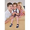 happy young family with kids in bright modern living room have fun and looking big flat lcd tv