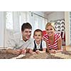 happy young family with kids in bright modern living room have fun and looking big flat lcd tv