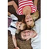 happy young family with kids in bright modern living room have fun and looking big flat lcd tv