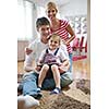 happy young family with kids in bright modern living room have fun and looking big flat lcd tv