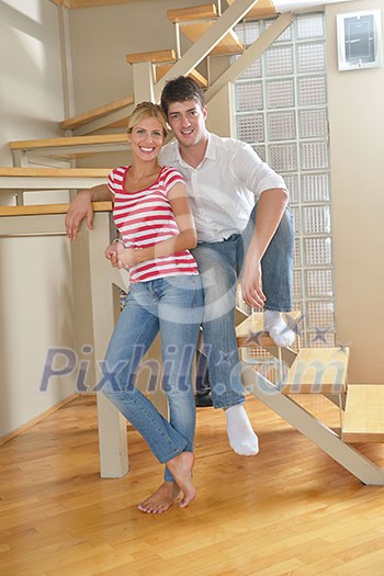 Relaxed young couple watching tv at home in bright living room Relaxed young couple watching tv at home in bright living room