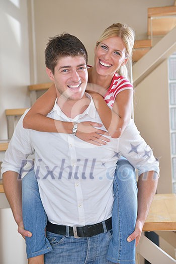 Relaxed young couple watching tv at home in bright living room Relaxed young couple watching tv at home in bright living room