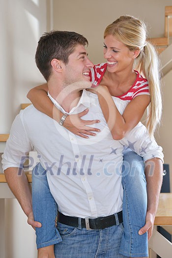 Relaxed young couple watching tv at home in bright living room Relaxed young couple watching tv at home in bright living room
