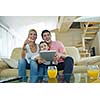 happy young family using tablet computer at modern  home for playing games and education