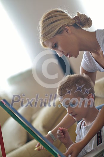 happy young family teach leassons and prepare their son for school while draw on board at home happy young family teach leassons and prepare their son for school while draw on board at home