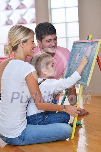 happy young family teach leassons and prepare their son for school while draw on board at home happy young family teach leassons and prepare their son for school while draw on board at home