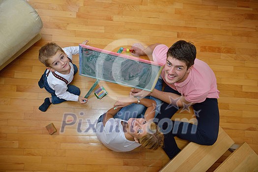 happy young family teach leassons and prepare their son for school while draw on board at home happy young family teach leassons and prepare their son for school while draw on board at home