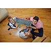 happy young family teach leassons and prepare their son for school while draw on board at home