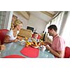 happy young family have healthy breakfast at kitchen with red details on bright morning light