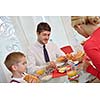 happy young family have healthy breakfast at kitchen with red details on bright morning light