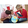 happy young family have fun with globe