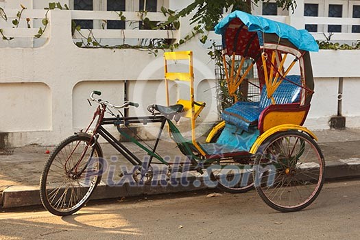 Empty bicycle rickshaw in street. Pondicherry, South India Empty bicycle rickshaw in street. Pondicherry, South India