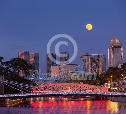 Singapore skyline. Singapore river and Cavenagh Bridge in the evening Singapore skyline. Singapore river and Cavenagh Bridge in the evening