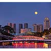 Singapore skyline. Singapore river and Cavenagh Bridge in the evening