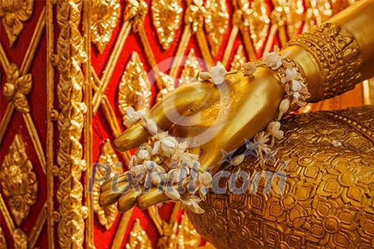 Buddha statue hand with flowers. Wat Phra That Doi Suthep, Chiang Mai, Thailand Buddha statue hand with flowers. Wat Phra That Doi Suthep, Chiang Mai, Thailand
