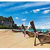 Long tail boats on tropical beach in Thailand