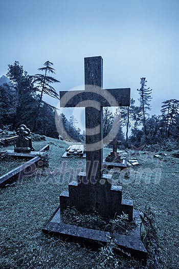 Spooky Halloween graveyard in fog in moonlight Spooky Halloween graveyard in fog in moonlight