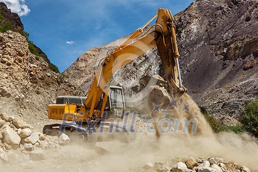 Excavator doing road construction in Himalayas. Ladakh, Jammu and Kashmir, India Excavator doing road construction in Himalayas. Ladakh, Jammu and Kashmir, India
