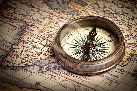 Old vintage retro compass on ancient map Old vintage retro compass on ancient map