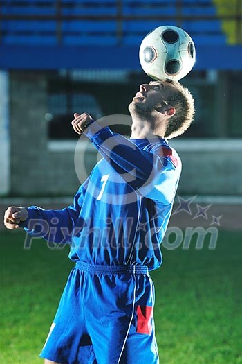 soccer player doing kick with ball on football stadium field isolated on black background in night soccer player doing kick with ball on football stadium field isolated on black background in night