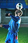 soccer player doing kick with ball on football stadium  field  isolated on black background  in night