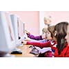it education with children group  in school at computer science class learning leassons and practice typing 