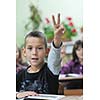 happy young boy at first grade math classes solving problems and finding solutions