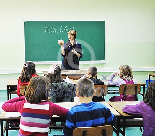 happy children group in school classrom taking notes and learning biology and anatomy lessons with teacher happy children group in school classrom taking notes and learning biology and anatomy lessons with teacher