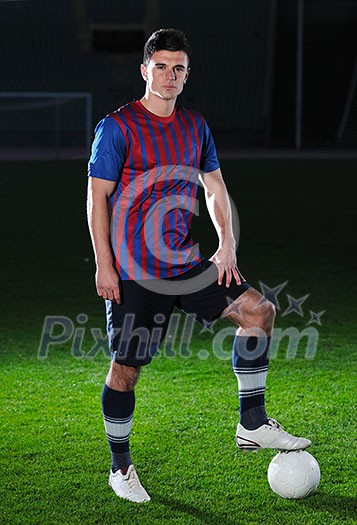portrait of young handsome soccer player man at football stadium and green grass portrait of young handsome soccer player man at football stadium and green grass