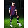 portrait of young handsome soccer player man at football stadium and green grass