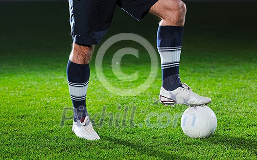 soccer player doing kick with ball on football stadium field isolated on black background in night soccer player doing kick with ball on football stadium field isolated on black background in night