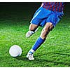 soccer player doing kick with ball on football stadium  field  isolated on black background  in night