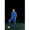 soccer player doing kick with ball on football stadium  field  isolated on black background