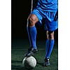 soccer player doing kick with ball on football stadium  field  isolated on black background