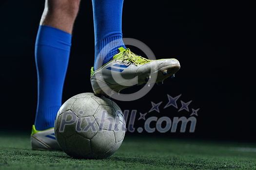 soccer player doing kick with ball on football stadium field isolated on black background soccer player doing kick with ball on football stadium field isolated on black background
