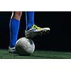 soccer player doing kick with ball on football stadium  field  isolated on black background