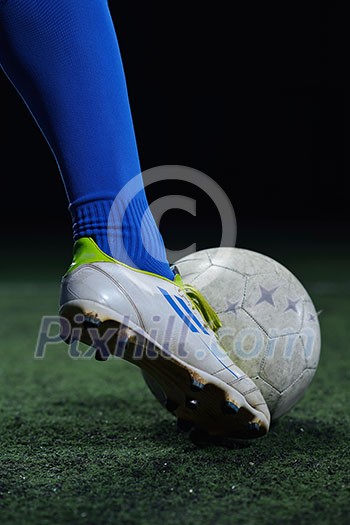 soccer player doing kick with ball on football stadium field isolated on black background soccer player doing kick with ball on football stadium field isolated on black background