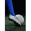 soccer player doing kick with ball on football stadium  field  isolated on black background