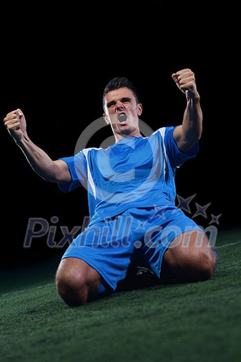 soccer player doing kick with ball on football stadium field isolated on black background soccer player doing kick with ball on football stadium field isolated on black background