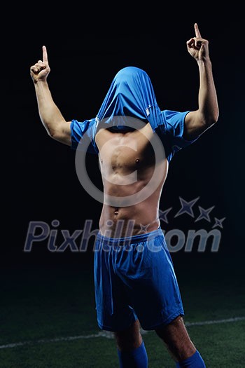 soccer player doing kick with ball on football stadium field isolated on black background soccer player doing kick with ball on football stadium field isolated on black background