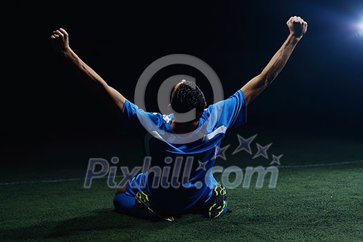 soccer player doing kick with ball on football stadium field isolated on black background soccer player doing kick with ball on football stadium field isolated on black background