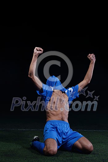 soccer player doing kick with ball on football stadium field isolated on black background soccer player doing kick with ball on football stadium field isolated on black background