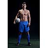 soccer player doing kick with ball on football stadium  field  isolated on black background