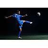 soccer player doing kick with ball on football stadium  field  isolated on black background