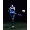 soccer player doing kick with ball on football stadium  field  isolated on black background