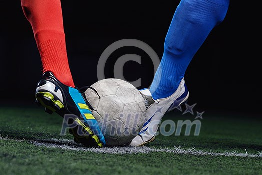 soccer player doing kick with ball on football stadium field isolated on black background soccer player doing kick with ball on football stadium field isolated on black background