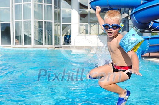 happy kids have fun on outdoor swimming pool at beautiful aquapark