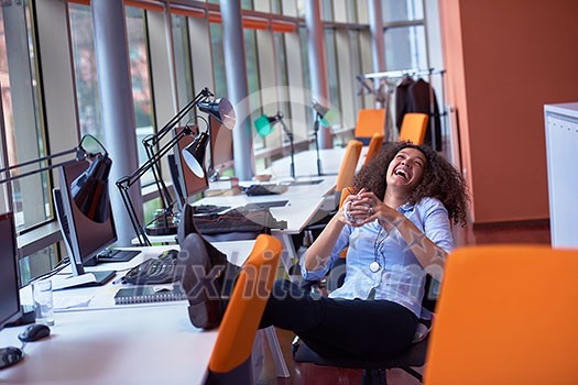 happy young curly business woman in the modern office have coffee break and relaxing happy young curly business woman in the modern office have coffee break and relaxing