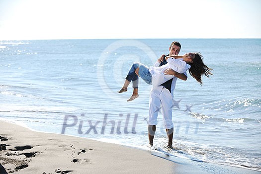 happy young couple in white clothing have romantic recreation and fun at beautiful beach on vacations happy young couple in white clothing have romantic recreation and fun at beautiful beach on vacations