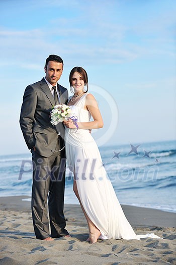 happy just married young couple celebrating and have fun at beautiful beach sunset happy just married young couple celebrating and have fun at beautiful beach sunset